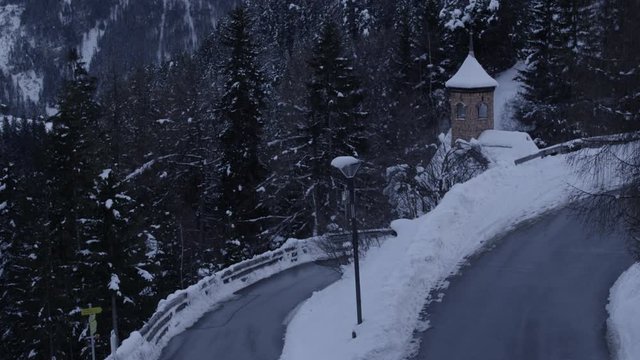tilt from mountain over alpine little church and road serfaus