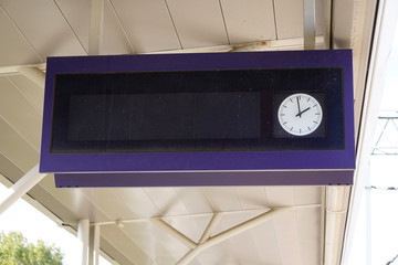 scoreboard at the station with a clock for the schedule, track and platform, as well as the departure time. waiting for the arrival or departure of trains, trains