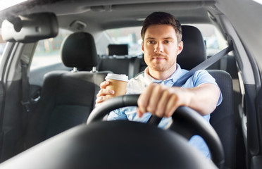 transport, vehicle and people concept - man or driver with takeaway coffee cup driving car