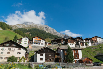 Fototapeta na wymiar picturesque mountain village with white stone houses and stone roofs in the Swiss Alps
