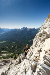 young attractive blonde female mountain climber in the Dolomites of Italy