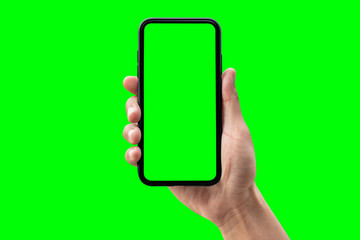 Hand holding smartphone isolated on green background.
