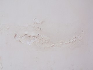background of the damaged house wall and water stains with broken color and crack