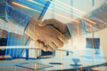 Multi exposure of financial graph on office background with two businessmen handshake. Concept of success in business