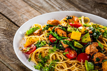 Spaghetti with chicken meat, avocado,mango and cherry tomatoes