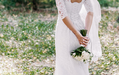 Beautiful bride with a bouquet of flowers of white colors