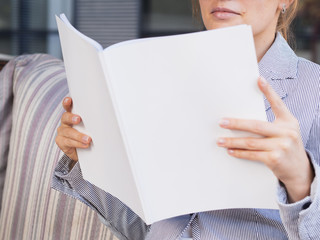 Close-up woman reading a mock-up magazine