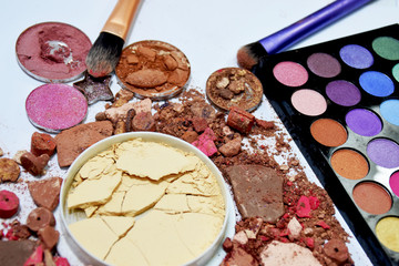 Eye shadow colorful and powder shattered into powder. Make up brush.