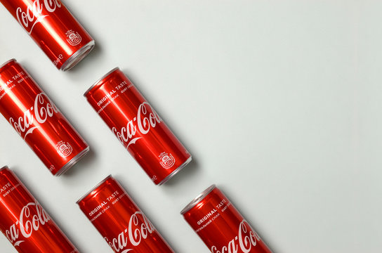 Flat Lay Shot Carbonated Red Drink Tin Cans Coca Cola Laying On Pastel Blue Background