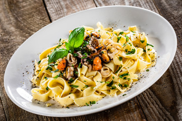 Tagliatelle with with seafood on white plate