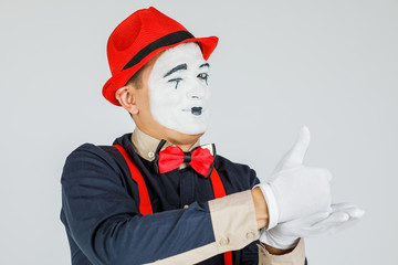 A MIME artist does tricks with his hands. Funny MIME show, a talented actor. Isolated on white...