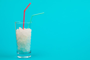 Glass of sugar. The concept of junk food. On red background.