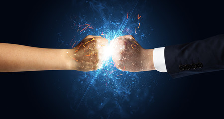 Obraz na płótnie Canvas Two hands fighting with light, glow, spark and smoke concept