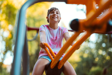 Girl playing at the playground on a seesaw