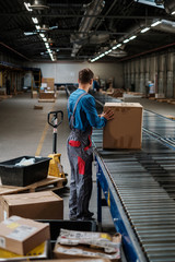 Fototapeta na wymiar Warehouse worker working on a conveyor line