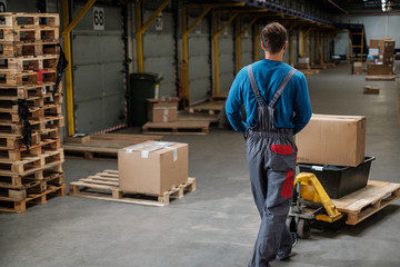 Warehouse worker with a pallet rack