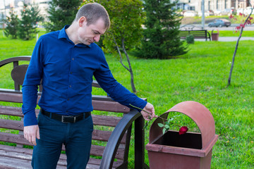 A sad man did not wait for his beloved and in desperation threw the rose into the trash