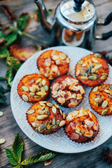 Healthy fall vegetarian dessert. Apple cupcake with pumpkin, almond seeds and spices.