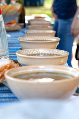 clay plates with soup on the table