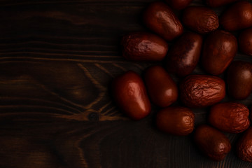 Juicy dates on a old wooden table,  a healthy alternative to sweets concept. Copy space , selective focus