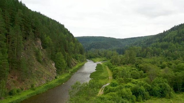 Flying above Maliy Inzer river among green forest
