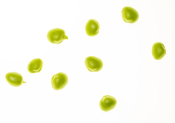 Green pea seeds (chícharos, petipuas), tender and very fresh (with drops of water). Isolated on white background.