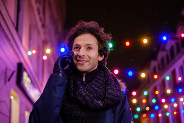 Man with a mobile phone on a cold winter evening