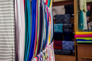 Rolls of fabric and textiles in a natural cotton factory shop bazar