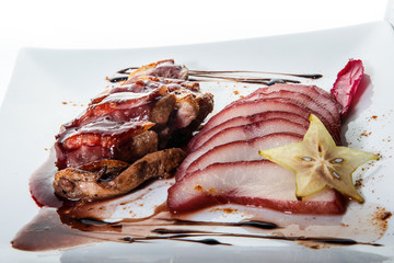 closeup finely decorated restaurant dish of sliced fried duck breast