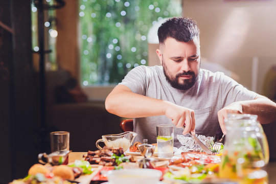 Man At The Big Table With Food.