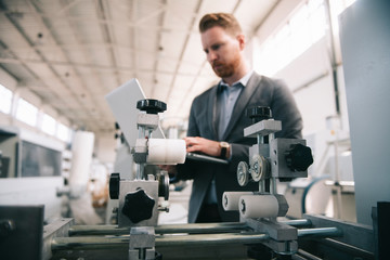 Manager checks machines at the factory. Inspector checks a factory.