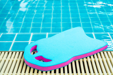 Blue and purple foam board To learn to swim Placed at the edge of the pool