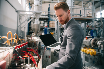 Manager checks machines at the factory. Inspector checks a factory.