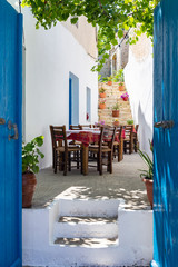 Streetview of Crete with whitewashed walls and blue doors and windows, Greece