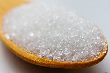 closeup sugar in wooden spoon