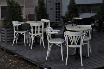 tables and chairs on the street veranda