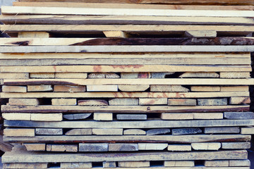 A pile of boards stacked on top of each other. Wooden boards, lumber, industrial wood, timber