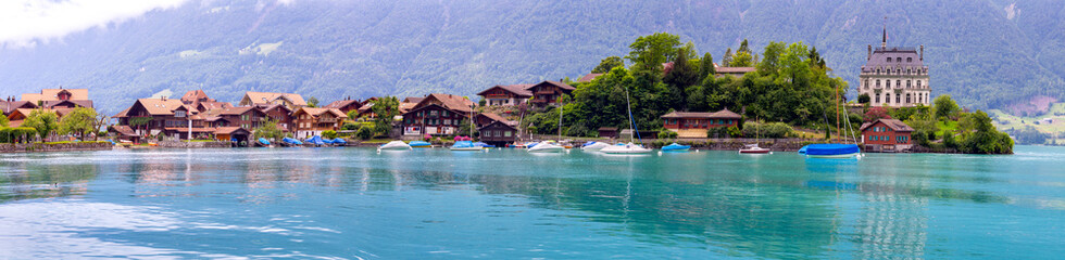Fototapeta na wymiar Panorama of the Swiss village of Iseltwald on the famous Lake Brienz. Switzerland.