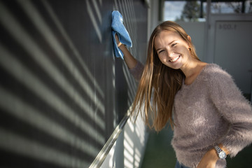 Pretty, young female student in front of a blackboard during math class