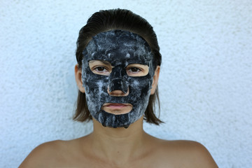 Bubble oxygen charcoal black mask. Face treatment. Popular sheet face mask anti blemish and acne. Famous beauty trend.