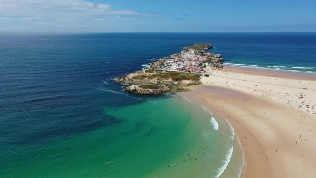Aerial view of island Baleal naer Peniche on the shore of the ocean in west coast of Portugal. Baleal Portugal with incredible beach and surfers. Aerial footage of Baleal, Portugal. 4k quality