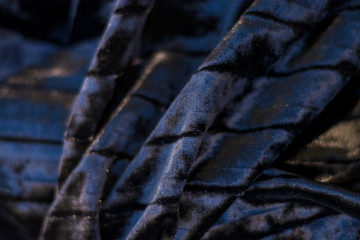  Background or texture of black and plain, iridescent, velor, corrugated fabric. Drapery.