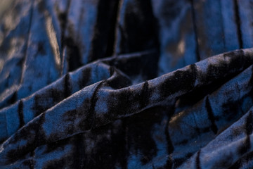  Background or texture of black and plain, iridescent, velor, corrugated fabric. Drapery.
