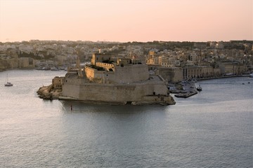 Valletta, Malta, August 2019. Fort St. Angelo in the rays of the rising sun.