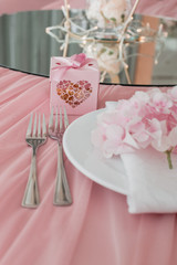 Table setting and decor. Forks, knives, glass, plate, towel and flower.