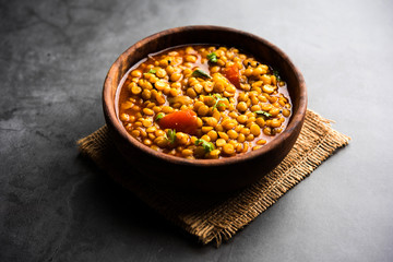 Chana Dal fry or Split Bengal Gram tadka served in a bowl or pan, selective focus