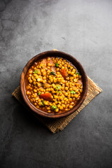 Chana Dal fry or Split Bengal Gram tadka served in a bowl or pan, selective focus