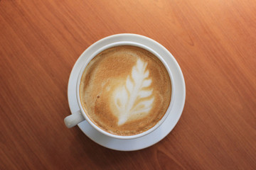 cup of coffee on wooden background