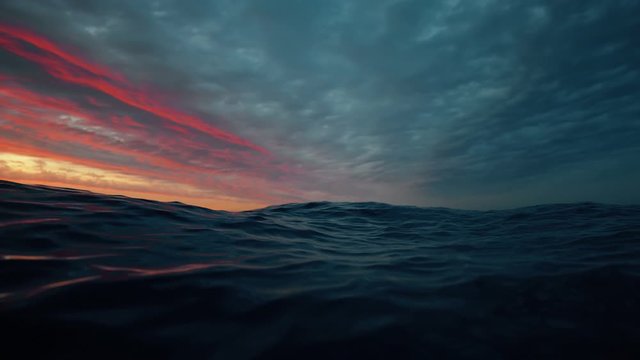 Sea wave close up, low angle view, slow motion sunrsie shot