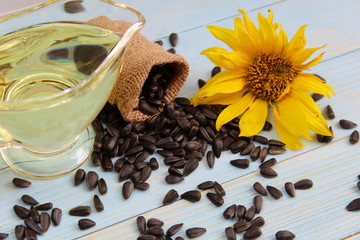 overturned small bag with sunflower seeds on a background of oil in a 